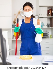 Office Cleaner In Protective Mask Is Satisfied After Cleaning In Modern Office