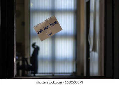 Office Is Closed With A Sign 'Work From Home'. Business Company Asks Worker To Work Remotely During Quarantine Period To Prevent Coronavirus Or COVID-19 Infection. Office Space Is Empty With People