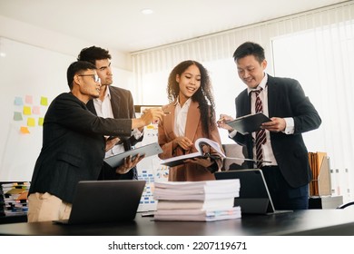 Office colleagues have a casual discussion. During a meeting in a conference room, a group of business teem sit in the conference room new startup project in sun light

