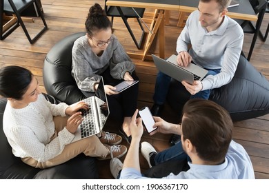 Office colleagues using digital devices during meeting, consulting internet for new ideas and brainstorming. Millennial employees browsing social media during work break. Online communication concept - Powered by Shutterstock