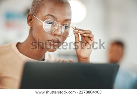 Office, computer and black woman with glasses, serious or reading email, online research or report. Laptop, concentration and African journalist proofreading article for digital news website or blog