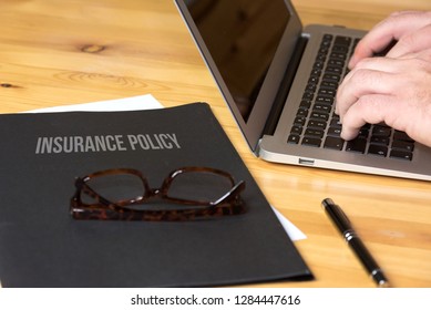 An office, computer and a folder with insurance policy