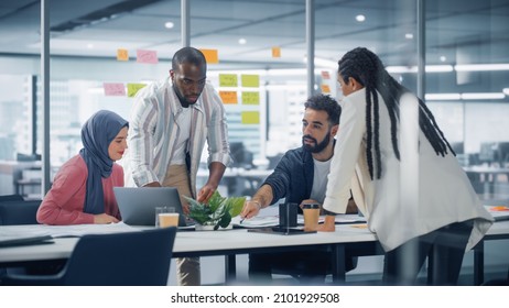 Office Conference Room Meeting: Diverse Team of Young Investors, Workers, Developers work on Creative e-Commerce Digital Startup. Group of Multi-Ethnic Business Professionals work on Product Strategy