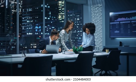 Office Conference Room Meeting: Diverse Team of Top Managers Talk, Brainstorm, Use Laptop Computer. Business Partners Discuss Financial Reports, Plan Operations Based on Line and Pie Graph Reports. - Powered by Shutterstock