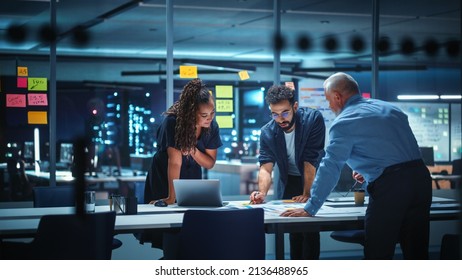 Office Conference Room Meeting: Diverse Team of Top Managers Talk, Brainstorm, Use Digital Tablet. Business Partners Discuss Financial Reports, Plan Investment Strategy. Team of Three - Powered by Shutterstock