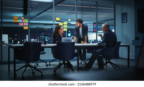 Office Conference Room Meeting: Diverse Team of Top Managers Talk, Brainstorm, Use Digital Tablet. Business Partners Discuss Financial Reports, Plan Investment Strategy. Team of Three - Powered by Shutterstock