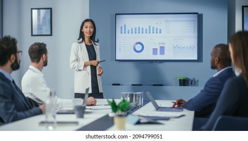 Office Conference Room Meeting: Portrait of Confident Asian Female Top Manager Presents e-Commerce Investment Strategy for Group of Digital Entrepreneurs. Wall TV with Big Data Analysis, Infographics - Shutterstock ID 2094799051