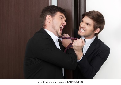 Office Conflict. Two Angry Young Business Men Fighting At Office