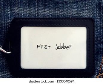 An office / corporate ID card on denim jeans background with text FIRST JOBBER