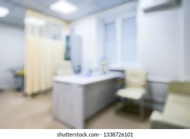 Doctor’s Office As Creative Abstract Blur Background. Inside Modern Consulting Room In Clinic. Blurry Photo Of Empty Light Doctor’s Cabinet In Contemporary Hospital. Concept Of Medical Service.