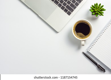 Office Desk With Coffee Cup, Blank Notebook, Black Pen, Laptop Computer And Cactus Pot, Top View Design