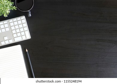 Office Desk Computer Keyboard, Coffee, Pencil And Notepad Paper On Black Table, Copy Space Concept Topview.