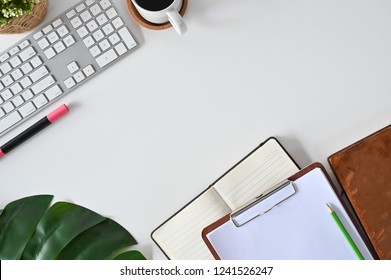 Office desk concept, Top view workspace hipster with computer, coffee, books and leaf decoration. - Powered by Shutterstock