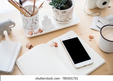 office desk flat lay with coffe, smartphone and succulents, styl