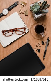 Office Desk With Ipad, Agenda, Glasses And Clips In A Woody Background 