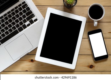 Office Desk With Laptop, Blank Screen Tablet, Blank Screen Smart Phone And Cup Of Coffee Top View.Flat Lay