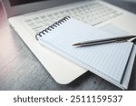 Office desk laptop computer with empty blank notebook pen, workplace at remote work. Flat lay, top view
