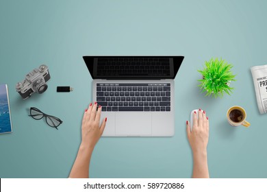 Office Desk With Laptop Computer. Woman Work On Computer With Blank Screen For Design Presentation. Top View Of Clean Tidy Desk.