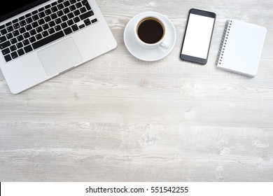 Office Desk With Laptop, Smartphone, Cup Of Coffee. Top View With Copy Space.