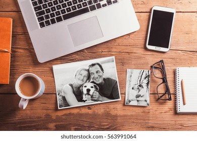Office desk. Objects and black-and-white photos of senior couple