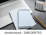 office desk open notepad for notes, pen laptop and calculator as workplace at remote work. Top view