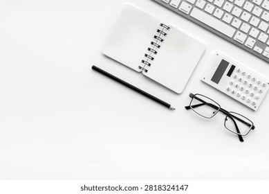 Office desk in order. Geometry. Computer keyboard and office supplies, glasses on white background top view.
