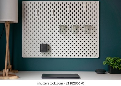 Office Desk With Pegboard And Closed Laptop