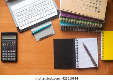 Office desk table with computer, calculator, supplies. Copy space for text.