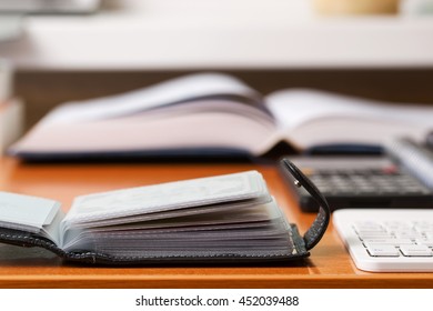 Office desk table with computer, calculator, supplies. Copy space for text.