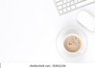 Office Desk Table With Computer And Coffee Cup. Top View With Copy Space