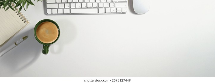 Office desk table with computer, cup of coffee and supplies. Top view with copy space panorama, flat lay.