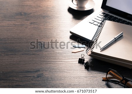 Office desk table with computer, silver pen and black coffee cup. Business desk table top view with copy space concept.