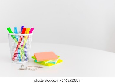 Office desk table with computer, supplies, sticky notes and coloured pens. Top view with copy space. Flat lay. Time management	.  - Powered by Shutterstock