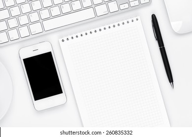 Office desk table with computer, supplies and coffee cup. Top view with copy space  - Powered by Shutterstock