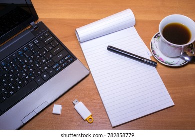Office desk table with computer,note paper, coffee and flash memory