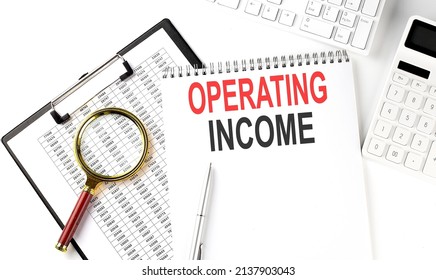 Office Desk Table With Keyboard, Notepad ,chart And Calculator. Top View With OPERATING INCOME