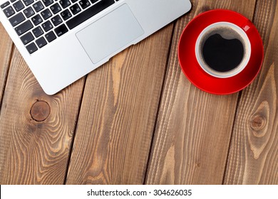 Office desk table with laptop computer and coffee cup. Top view with copy space - Powered by Shutterstock