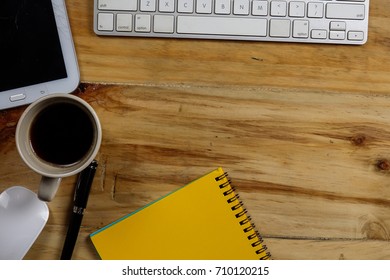 Office desk table with laptop computer and coffee cup . Top view