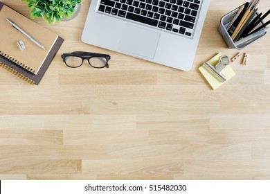 Office desk table with laptop, supplies and tablet . Top view with copy space - Shutterstock ID 515482030