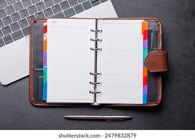 Office desk table with notepad, cup of coffee and supplies. Top view with copy space. Flat lay