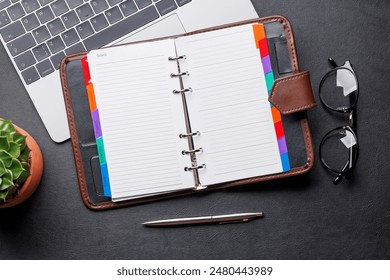 Office desk table with notepad, cup of coffee and supplies. Top view with copy space. Flat lay