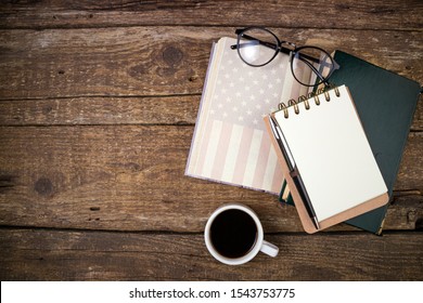 Office Desk Table With Old Book, Coffee Cup, American History Book, Notebook And Eyeglasses. Educaions, Studing, Goal, Strategy, Politics, International Relations, Economics, American History Concept