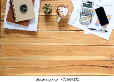 Office Desk Table With Stack Of Business Report Paper File, Calculator,smart Phone,cup Of Coffee And Financial Report.Top View With Copy Space.Working Desk Table Concept.