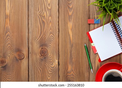 Office Desk Table With Supplies, Coffee Cup And Flower. Top View With Copy Space