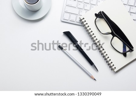 Calendar with pen and glasses on yellow background