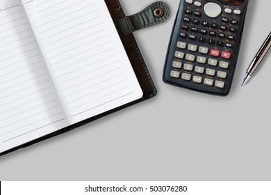 Office Desk Table With Supplies, Notebook, Calculator And Pen. Top View With Copy Space