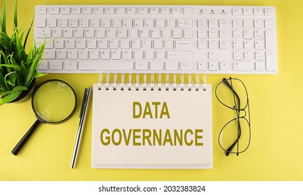 Office Desk Table Top View With Keyboard And Notebook Text DATA GOVERNANCE On The Yellow Background