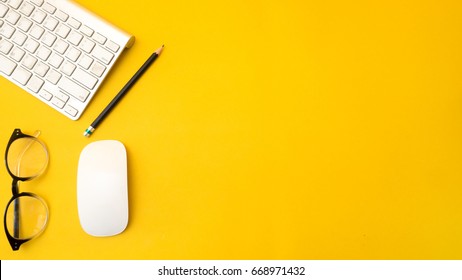 Office Desk Table Top View With Keyboard Copy Space Yellow Background