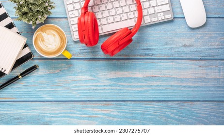 Office desk workplace with keyboard, mouse, headphone, pen, notebook and cup of coffee, Top view flat lay with copy space. - Powered by Shutterstock