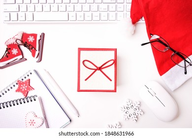 Office desktop workspace with computer and gift. Top view, flat lay.